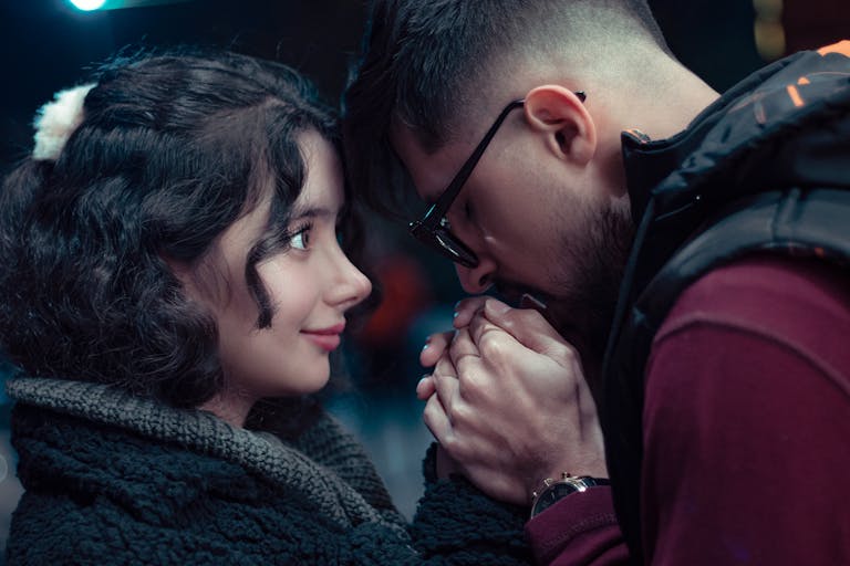 A couple shares a tender moment in Mashhad at dusk, highlighting affection and connection.